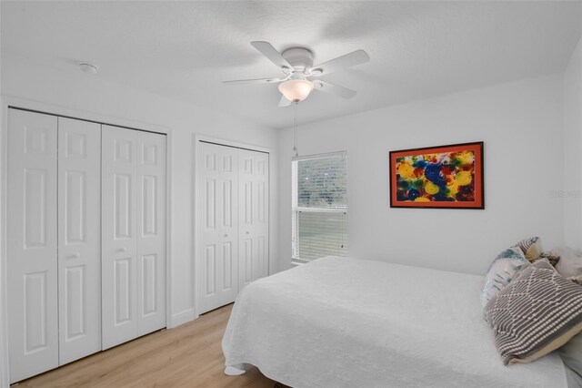 189 Blackstone Creek Rd, Groveland, FL 34736 - bedroom with multiple closets, light wood-type flooring, and a ceiling fan