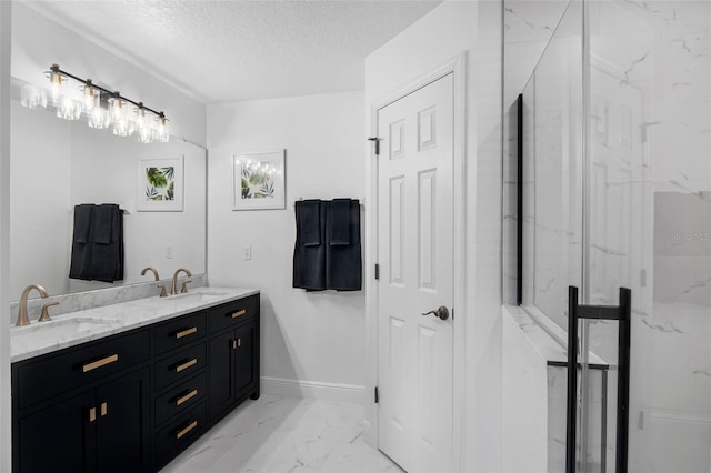 189 Blackstone Creek Rd, Groveland, FL 34736 - bathroom with double vanity, marble finish flooring, and a textured ceiling