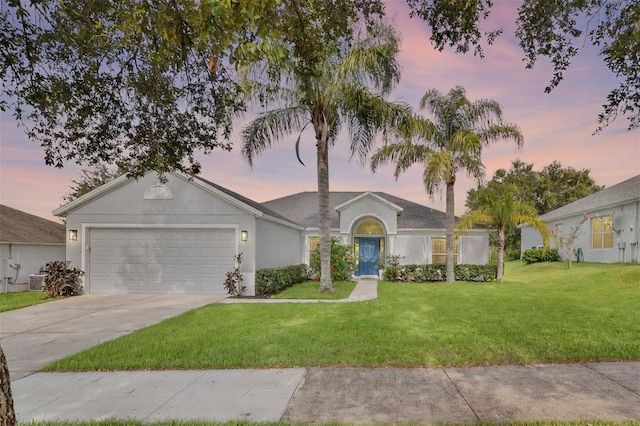 189 Blackstone Creek Rd, Groveland, FL 34736 - single story home featuring driveway, an attached garage, a yard, and stucco siding