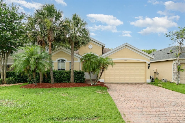 3896 Esplanade Ave, Port Orange, FL 32129 - view of front of house featuring stucco siding, driveway, a front yard, and a garage