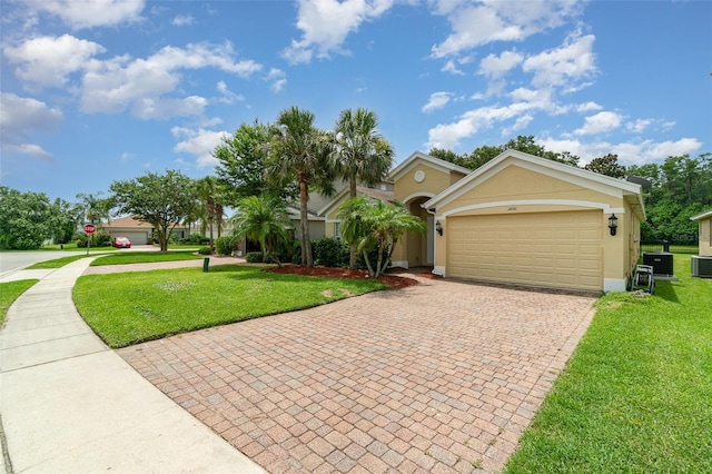 3896 Esplanade Ave, Port Orange, FL 32129 - view of front facade featuring decorative driveway, a front yard, a garage, and stucco siding