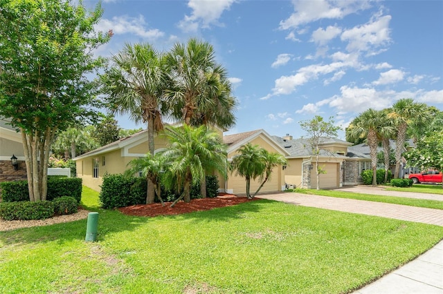 3896 Esplanade Ave, Port Orange, FL 32129 - view of front of home with a front yard, driveway, stucco siding, and a garage