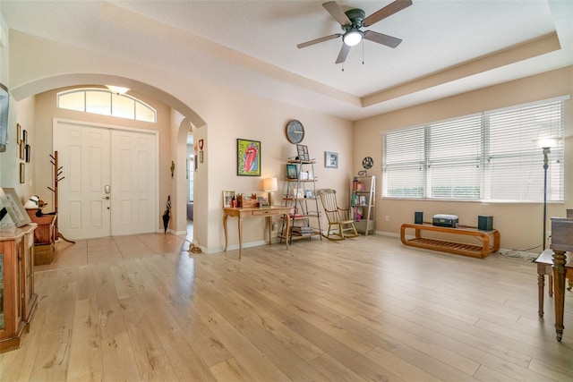 3896 Esplanade Ave, Port Orange, FL 32129 - entryway with arched walkways, a ceiling fan, light wood-type flooring, and a raised ceiling