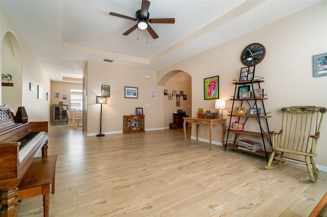 3896 Esplanade Ave, Port Orange, FL 32129 - sitting room with arched walkways, ceiling fan, light wood-style floors, and a tray ceiling
