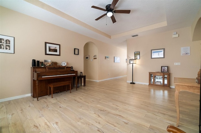 3896 Esplanade Ave, Port Orange, FL 32129 - living area with arched walkways, ceiling fan, light wood-type flooring, and a raised ceiling