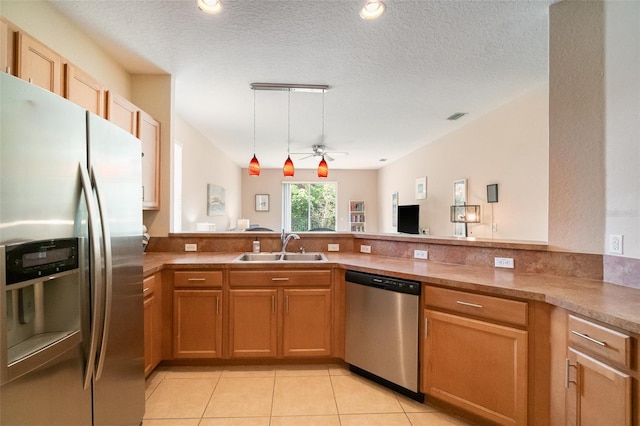 3896 Esplanade Ave, Port Orange, FL 32129 - kitchen with appliances with stainless steel finishes, a peninsula, light tile patterned flooring, a ceiling fan, and pendant lighting