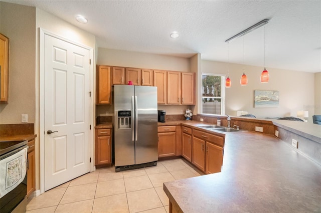 3896 Esplanade Ave, Port Orange, FL 32129 - kitchen with stainless steel appliances, hanging light fixtures, a peninsula, light tile patterned floors, and open floor plan