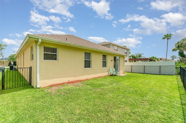 3896 Esplanade Ave, Port Orange, FL 32129 - back of property with stucco siding, a fenced backyard, and roof with shingles