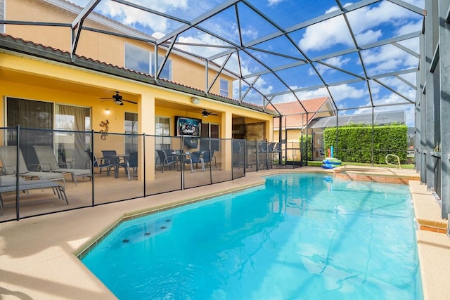 1428 Solana Cir, Davenport, FL 33897 - view of pool featuring a ceiling fan, a patio area, glass enclosure, and a pool with connected hot tub