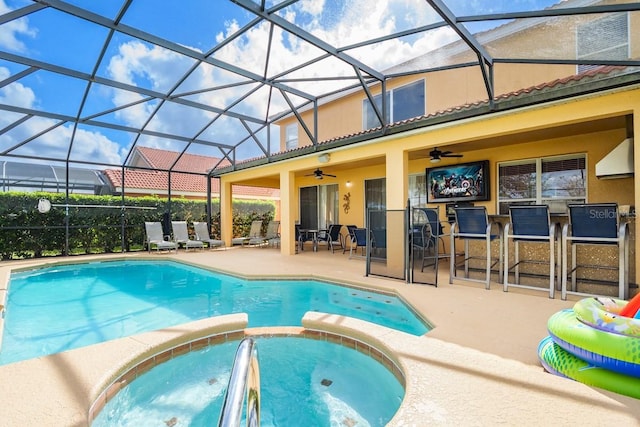 1428 Solana Cir, Davenport, FL 33897 - view of pool featuring a patio area, a pool with connected hot tub, a ceiling fan, glass enclosure, and exterior bar