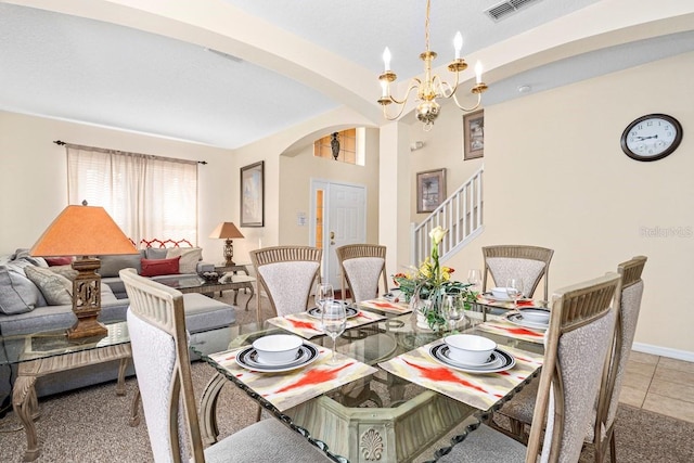 1428 Solana Cir, Davenport, FL 33897 - dining area with arched walkways, a chandelier, stairway, and tile patterned flooring