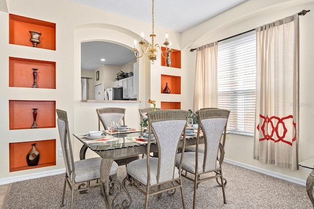 1428 Solana Cir, Davenport, FL 33897 - dining room featuring a chandelier, carpet floors, healthy amount of natural light, and arched walkways