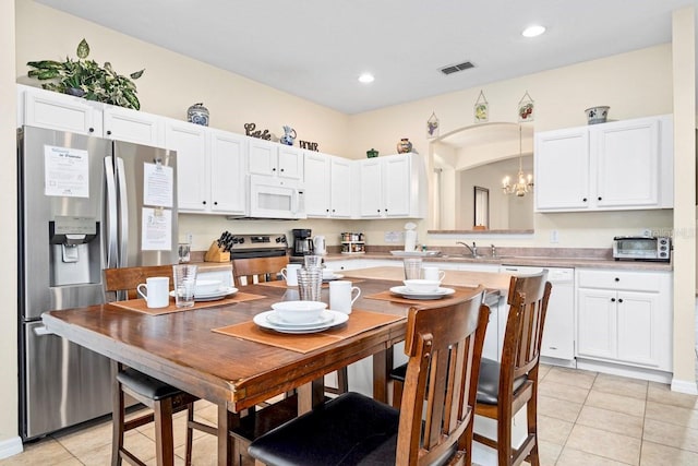 1428 Solana Cir, Davenport, FL 33897 - kitchen featuring stainless steel appliances, light tile patterned floors, white cabinetry, light countertops, and recessed lighting