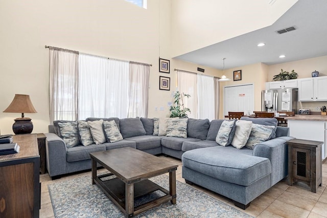 1428 Solana Cir, Davenport, FL 33897 - living area with light tile patterned flooring, a towering ceiling, and recessed lighting