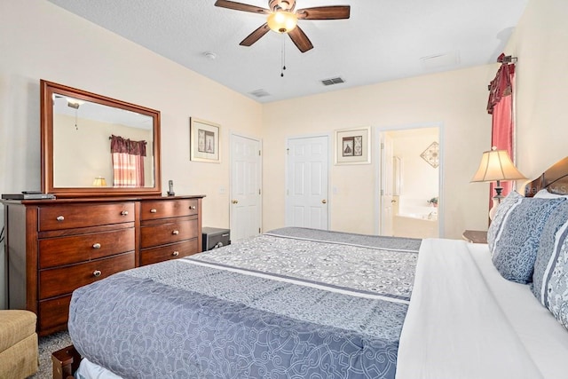1428 Solana Cir, Davenport, FL 33897 - bedroom with ceiling fan and connected bathroom