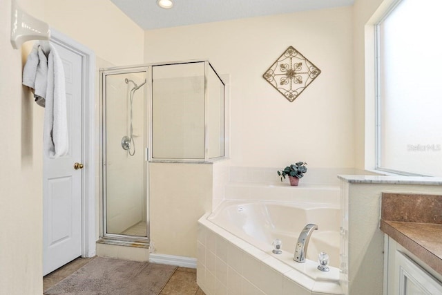 1428 Solana Cir, Davenport, FL 33897 - full bathroom with a bath, a stall shower, tile patterned flooring, and healthy amount of natural light