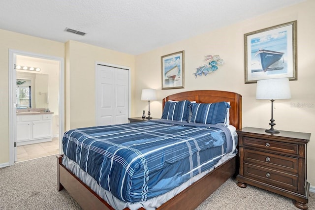 1428 Solana Cir, Davenport, FL 33897 - bedroom with light colored carpet, a closet, and ensuite bathroom