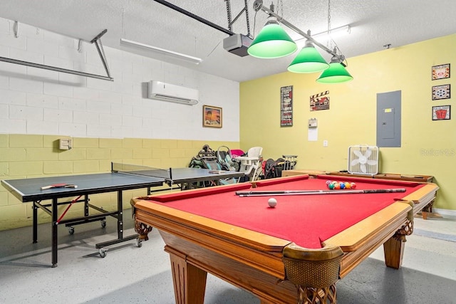 1428 Solana Cir, Davenport, FL 33897 - recreation room featuring electric panel, a wall unit AC, a textured ceiling, speckled floor, and concrete block wall