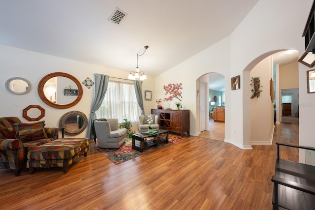 1646 Song Sparrow Ct, Sanford, FL 32773 - living area with arched walkways, wood finished floors, a chandelier, and high vaulted ceiling