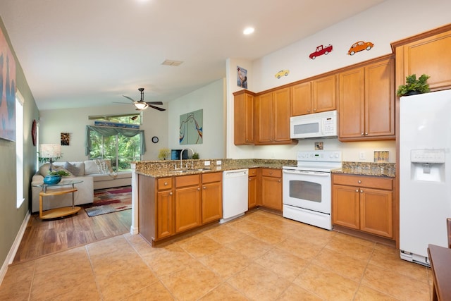 1646 Song Sparrow Ct, Sanford, FL 32773 - kitchen featuring white appliances, open floor plan, a peninsula, brown cabinets, and stone counters