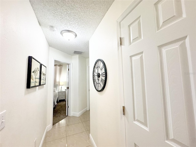 150 Barefoot Beach Way, Kissimmee, FL 34746 - hallway featuring a textured ceiling and light tile patterned flooring