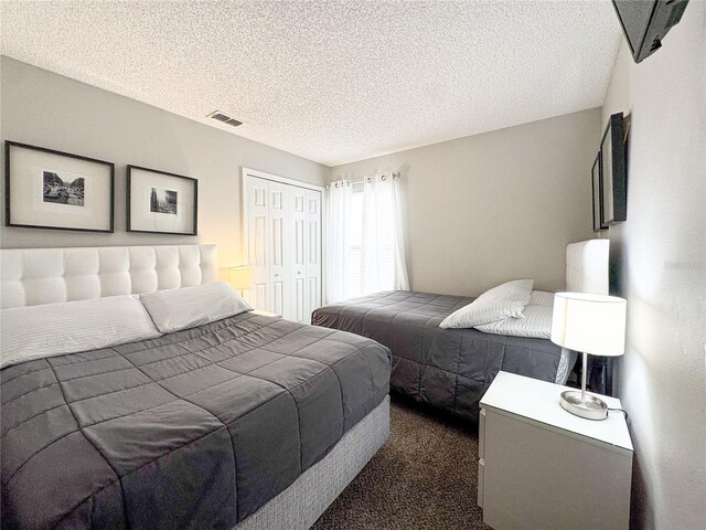 150 Barefoot Beach Way, Kissimmee, FL 34746 - bedroom with a closet, dark colored carpet, and a textured ceiling