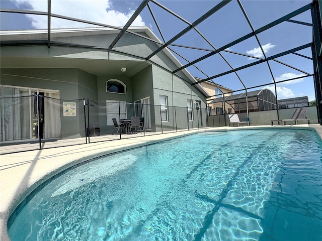 150 Barefoot Beach Way, Kissimmee, FL 34746 - swimming pool featuring a patio and glass enclosure