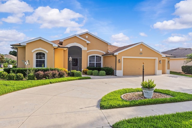 5339 Pond Crossing Pl, Leesburg, FL 34748 - view of front of house featuring stucco siding, an attached garage, and curved driveway