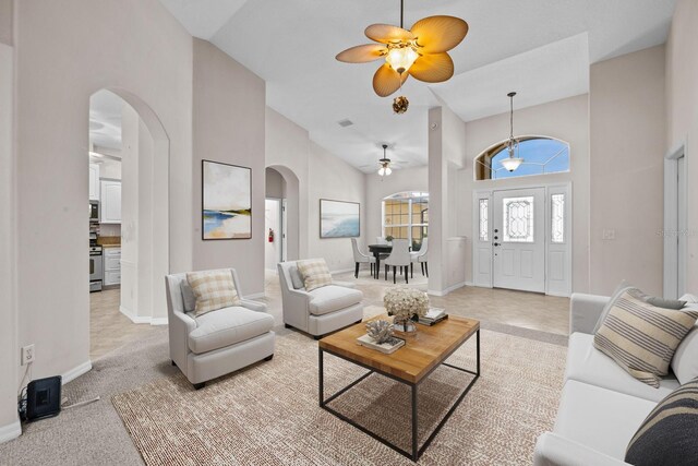 5339 Pond Crossing Pl, Leesburg, FL 34748 - living area featuring arched walkways, ceiling fan, and a towering ceiling