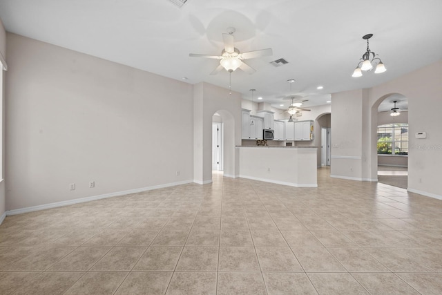 5339 Pond Crossing Pl, Leesburg, FL 34748 - unfurnished living room with a ceiling fan, arched walkways, light tile patterned floors, and recessed lighting