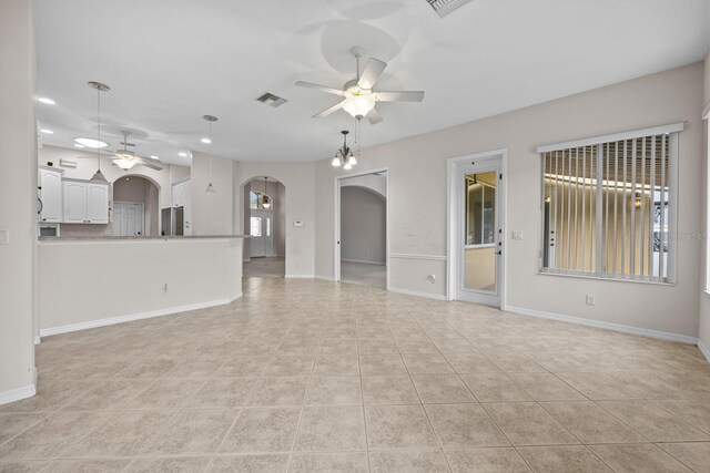 5339 Pond Crossing Pl, Leesburg, FL 34748 - unfurnished living room featuring ceiling fan, arched walkways, recessed lighting, and light tile patterned floors