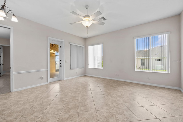 5339 Pond Crossing Pl, Leesburg, FL 34748 - spare room featuring ceiling fan, light tile patterned floors, and a chandelier