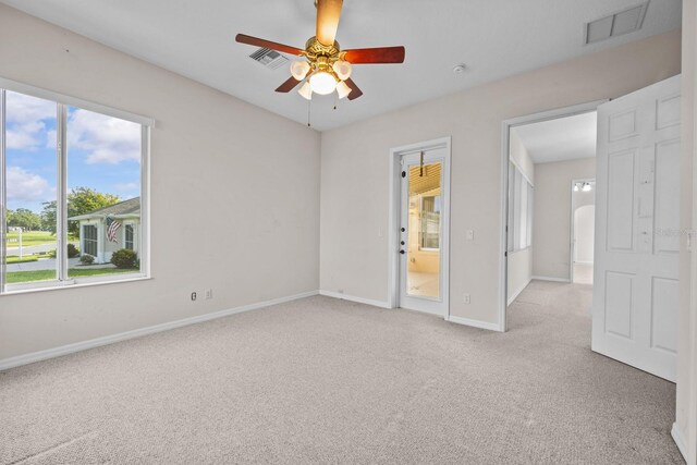 5339 Pond Crossing Pl, Leesburg, FL 34748 - spare room featuring light carpet, healthy amount of natural light, and ceiling fan