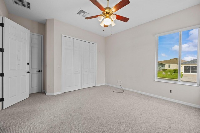 5339 Pond Crossing Pl, Leesburg, FL 34748 - unfurnished bedroom featuring carpet, multiple windows, a closet, and ceiling fan