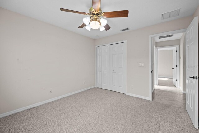 5339 Pond Crossing Pl, Leesburg, FL 34748 - unfurnished bedroom with carpet, a closet, and a ceiling fan