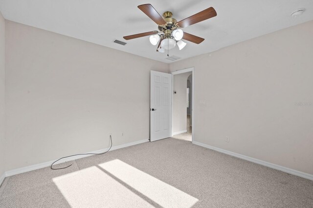 5339 Pond Crossing Pl, Leesburg, FL 34748 - spare room featuring light colored carpet, a ceiling fan, and a smoke detector
