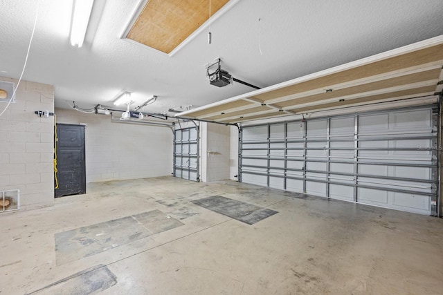 5339 Pond Crossing Pl, Leesburg, FL 34748 - garage featuring a garage door opener and concrete block wall