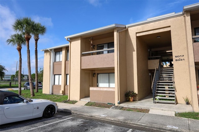 5027 Vineland Rd Unit 5027, Orlando, FL 32811 - view of building exterior featuring stairway and uncovered parking