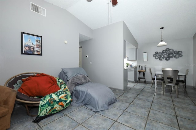 5027 Vineland Rd Unit 5027, Orlando, FL 32811 - living area featuring vaulted ceiling, light tile patterned flooring, and a ceiling fan