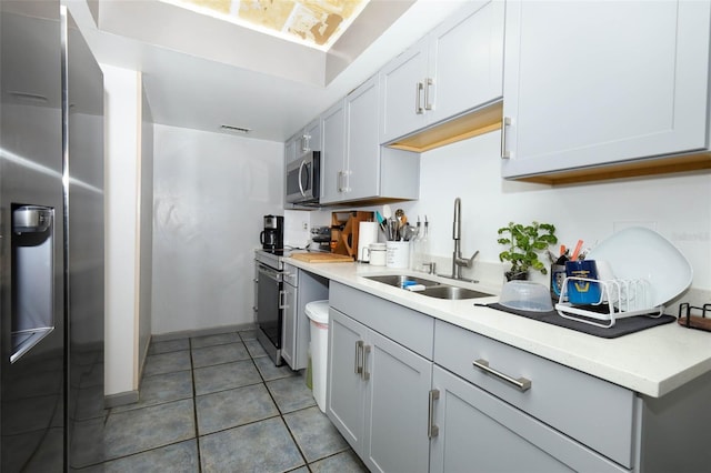 5027 Vineland Rd Unit 5027, Orlando, FL 32811 - kitchen with appliances with stainless steel finishes, light countertops, and light tile patterned floors