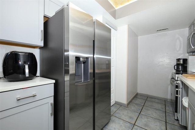 5027 Vineland Rd Unit 5027, Orlando, FL 32811 - kitchen with appliances with stainless steel finishes, light countertops, and light tile patterned floors