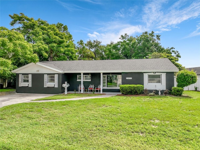 3417 Pershing Ave, Orlando, FL 32812 - ranch-style home featuring a front lawn, stucco siding, and roof with shingles