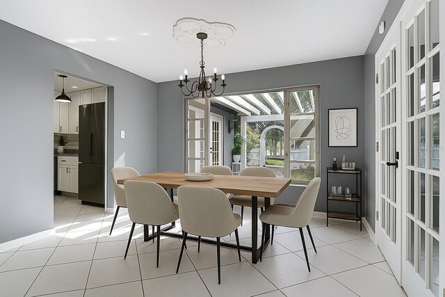 3417 Pershing Ave, Orlando, FL 32812 - dining area featuring a chandelier, light tile patterned floors, and french doors