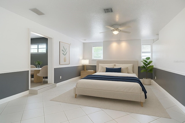 3417 Pershing Ave, Orlando, FL 32812 - bedroom featuring multiple windows, a textured ceiling, ceiling fan, and tile patterned floors