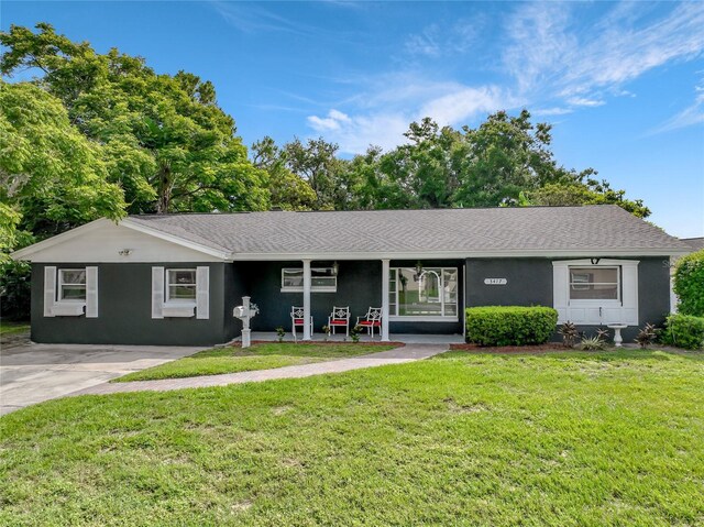 3417 Pershing Ave, Orlando, FL 32812 - single story home featuring a front lawn, stucco siding, and roof with shingles