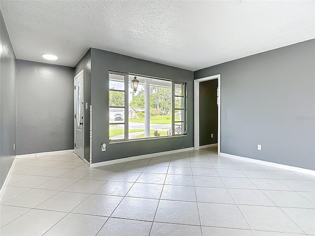 3417 Pershing Ave, Orlando, FL 32812 - empty room with a textured ceiling and light tile patterned flooring