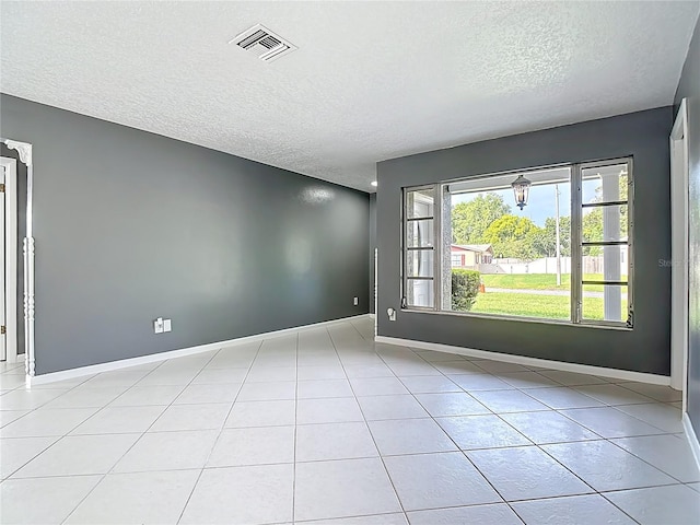 3417 Pershing Ave, Orlando, FL 32812 - empty room with a textured ceiling and light tile patterned floors
