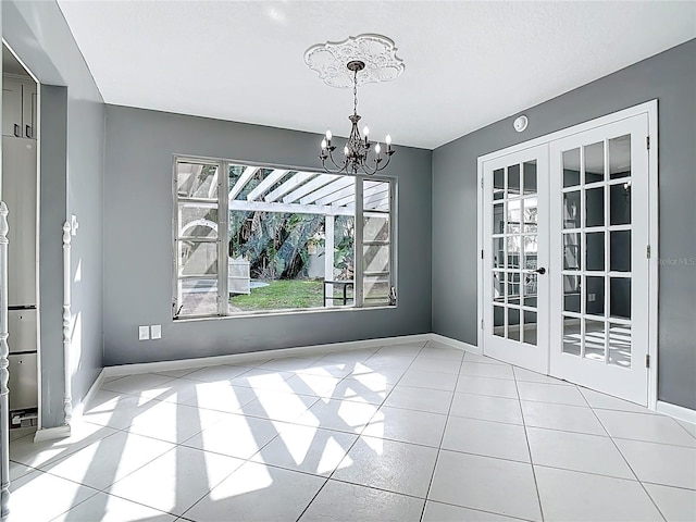 3417 Pershing Ave, Orlando, FL 32812 - unfurnished dining area featuring a chandelier, french doors, and tile patterned flooring