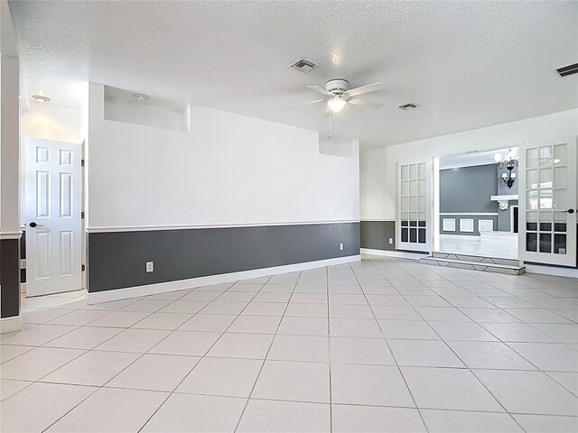 3417 Pershing Ave, Orlando, FL 32812 - spare room with ceiling fan, a textured ceiling, light tile patterned flooring, and a chandelier