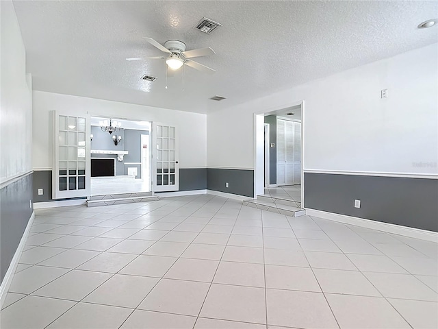 3417 Pershing Ave, Orlando, FL 32812 - unfurnished living room featuring a ceiling fan, a textured ceiling, a chandelier, and light tile patterned floors